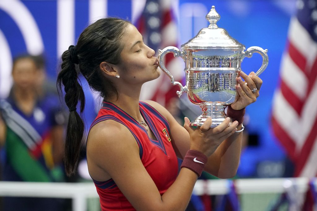 Emma Raducanu, of Britain, kisses the US Open championship trophy after defeating Leylah Fernandez, of Canada, during the women's singles final of the US Open tennis championships, Saturday, Sept. 11, 2021, in New York. (AP Photo/Seth Wenig)