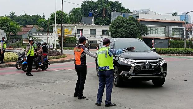 Petugas mengalihkan mobil pelat ganjil ke Jl Hang Lekir, Minggu (12/9/2021).