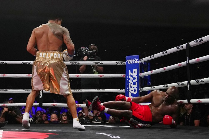 Former MMA star Vitor Belfort, left, knocks down former heavyweight champ Evander Holyfield during the first round of a boxing match Saturday, Sept. 11, 2021, in Hollywood, Fla. (AP Photo/Rebecca Blackwell)