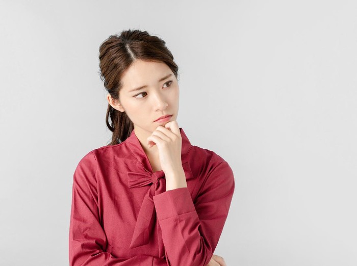 Thinking asian woman.