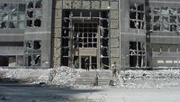 Tampak sebuah gedung yang seluruh jendela kacanya hancur pasca kejadian.  