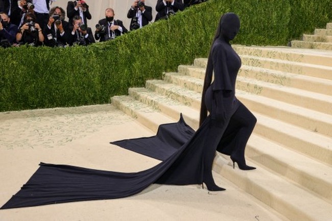 Baru-baru ini, Kim Kardashian membuat sebuah pernyataan fashion dengan gaun hitam Balenciaga di MET Gala 2021 yang bertema In America: A Lexicon of Fashion. Anti-mainstream, gaun yang menutupi sampai seluruh wajah dan kepalanya itu terbuat dari bahan kaus. Apa yang lebih Amerika dari t-shirt yang dipakai dari ujung kaki sampai kepala?! tulis Kim di Instagram untuk menanggapi kritikan yang menyerang gayanya tersebut.(Foto: Getty Images via AFP/THEO WARGO)