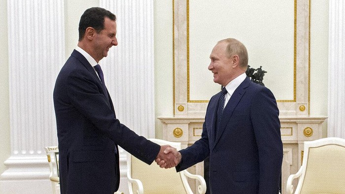 Russian President Vladimir Putin, right, greets Syrian President Bashar Assad during their meeting in the Kremlin in Moscow, Russia, Monday, Sept. 13, 2021. (Mikhail Klimentyev, Sputnik, Kremlin Pool Photo via AP)