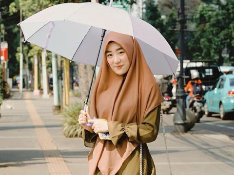 Larissa Chou yang memakai outfit serba earth tone.