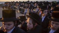 Yahudi Ultra-Ortodoks dari sekte Kiryat Sanz Hassidic berdoa di sebuah bukit yang menghadap ke Laut Mediterania saat mereka berpartisipasi dalam upacara Tashlich, di Netanya, Israel, Selasa (14/9/2021) waktu setempat. AP Photo/Ariel Schalit  