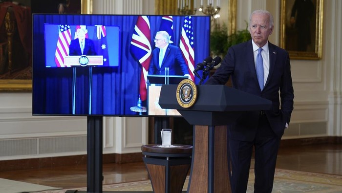 President Joe Biden, joined virtually by Australian Prime Minister Scott Morrison, right on screen, and British Prime Minister Boris Johnson, speaks about a national security initiative from the East Room of the White House in Washington, Wednesday, Sept. 15, 2021. (AP Photo/Andrew Harnik)