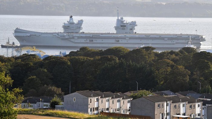ROSYTH, SCOTLAND - SEPTEMBER 19: The second of the new Royal Navy aircraft carrier HMS Prince of Wales departs from Rosyth dockyard on September 19, 2019 in Rosyth, Scotland. The vessel will sit at anchor in the River Forth for around 3-5 days following departure from the dockyard to complete a period of consolidation training before putting to sea for trials. (Photo by Jeff J Mitchell/Getty Images)