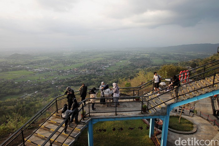 Wisatawan menikmati pemandangan alam yang disajikan di tempat wisata Heha Sky View, Dlingo, Gunung Kidul, Yogyakarta, Sabtu (18/9/2021). Geliat tempat wisata mulai terlihat setelah penurunan level PPKM.