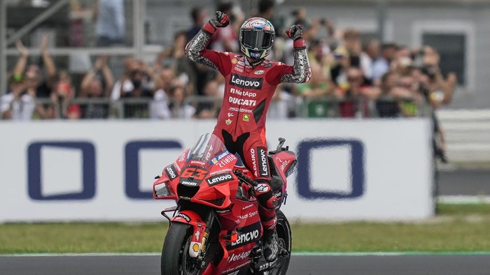 Francesco Bagnaia Italy's Francesco Bagnaia rides his Ducati as he celebrates winning the San Marino MotoGP race, at the Misano circuit in Misano Adriatico, Italy, Sunday, Sept. 19, 2021. (AP Photo/Antonio Calanni)