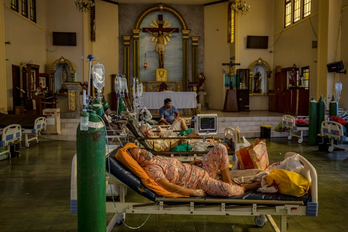 MANILA, PHILIPPINES - AUGUST 25: A healthcare worker moves an oxygen tank as patients infected with Covid-19 are treated at a chapel converted into a Covid-19 intensive care unit on August 25, 2021 in Quezon city, Metro Manila, Philippines. Hospitals in the Philippines are running out of beds for Covid-19 patients as the country struggles to cope with a huge wave of cases fueled by the more infectious Delta variant. Recording more than 1.8 million cases and more than 32,000 deaths, the Philippines continues to suffer the second-worst outbreak of the pandemic in Southeast Asia, with every one out of four people tested turning out positive for the coronavirus. (Photo by Ezra Acayan/Getty Images)