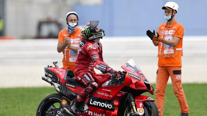 Italys Francesco Bagnaia looks up as he celebrates winning the San Marino MotoGP race, at the Misano circuit in Misano Adriatico, Italy, Sunday, Sept. 19, 2021. (AP Photo/Antonio Calanni)