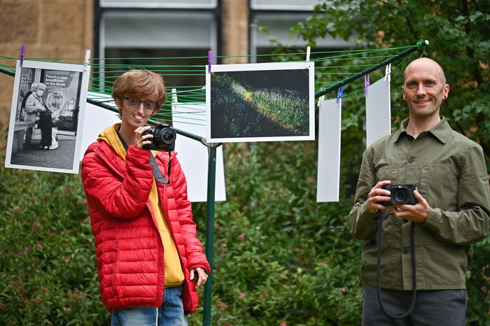 GLASGOW, SCOTLAND - SEPTEMBER 17: Brian Hartley and Dylan Lombard (R) pose beside their photographic exhibition in a tenement garden on September 17, 2021 in Glasgow, Scotland. “Stills of a Lockdown City” features images taken during the 2020 coronavirus lockdown by Glasgow-based artist Brian Hartley and 18-year-old Dylan Lombard, and aims to offer “a perspective that allows us to make more sense of the world”. It will take place on September 18 and 19, 2021. (Photo by Jeff J Mitchell/Getty Images)