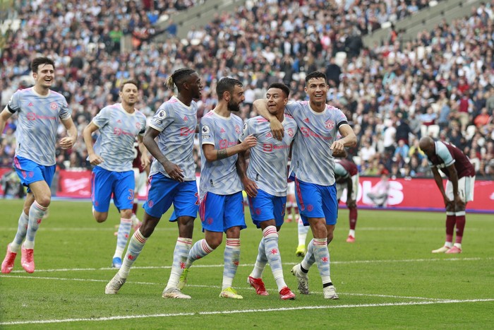 Manchester Uniteds Jesse Lindgard, second left, reacts with teammates after scoring his sides second goal during the English Premier League soccer match between West Ham United and Manchester United at the London Stadium in London, England, Sunday, Sept. 19, 2021. (AP Photo/Ian Walton)