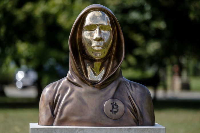 BUDAPEST, HUNGARY - SEPTEMBER 22: Students take selfies of a statue of Satoshi Nakamoto, a presumed pseudonym used by the inventor of Bitcoin, as it is displayed in Graphisoft Park on September 22, 2021 in Budapest, Hungary. The statue's creators, Reka Gergely and Tamas Gilly, used anonymized facial features, as Nakamoto's true identify remains unconfirmed. (Photo by Janos Kummer/Getty Images)