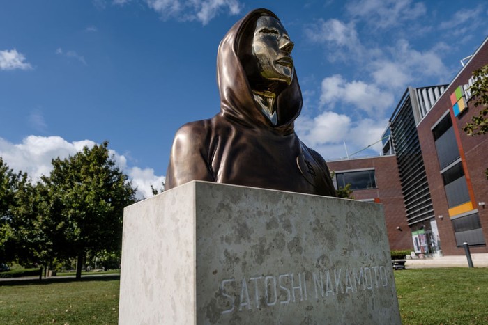 BUDAPEST, HUNGARY - SEPTEMBER 22: Students take selfies of a statue of Satoshi Nakamoto, a presumed pseudonym used by the inventor of Bitcoin, as it is displayed in Graphisoft Park on September 22, 2021 in Budapest, Hungary. The statue's creators, Reka Gergely and Tamas Gilly, used anonymized facial features, as Nakamoto's true identify remains unconfirmed. (Photo by Janos Kummer/Getty Images)