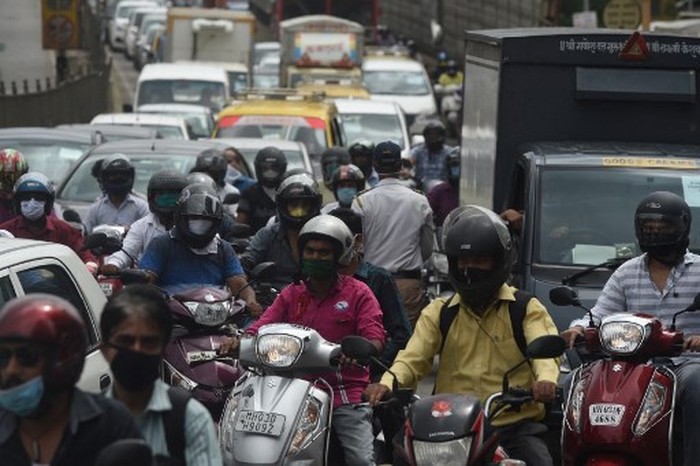 Commuters are seen in a traffic jam during rush hour as places of religious worship, hotels, restaurants and shopping malls are allowed to operate again after more than two months of lockdown imposed as a preventive measure against the COVID-19 coronavirus, in Mumbai on June 8, 2020. (Photo by Punit PARANJPE / AFP)