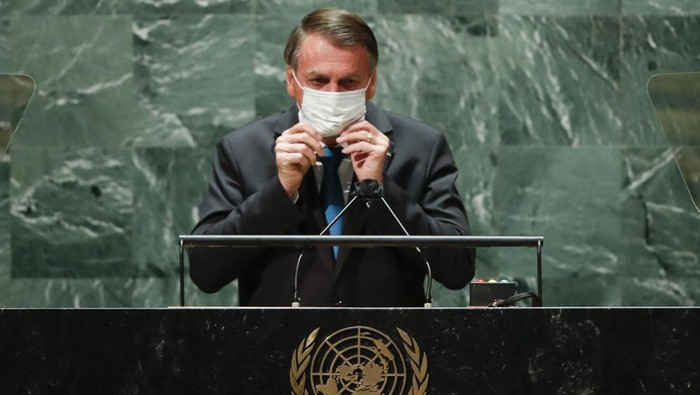 Brazils President Jair Bolsonaro puts back on a protective face mask after speaking during the 76th Session of the United Nations General Assembly at U.N. headquarters in New York on Tuesday, Sept. 21, 2021. (Eduardo Munoz/Pool Photo via AP)