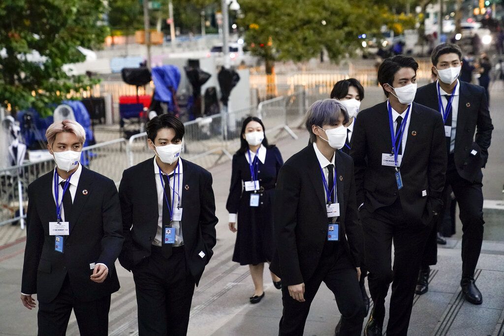 ADDS IDS - Members of the South Korean band BTS, from left, J-Hope, Jung Kook, Suga, Jimin, partially obscured, Jin and RM arrive to security check-in at United Nations headquarters, Monday, Sept. 20, 2021, during the 76th Session of the U.N. General Assembly in New York. (AP Photo/John Minchillo, Pool)