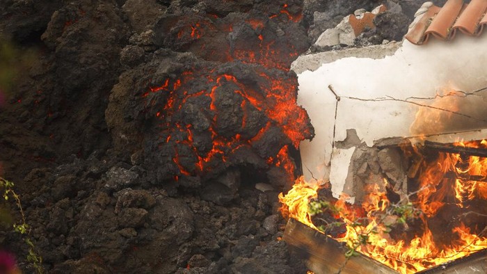 FILE - In this Monday Sept. 20, 2021 file photo, lava from a volcano engulfs a building near El Paso on the island of La Palma in the Canaries, Spain. A long-dormant volcano on a small Spanish island in the Atlantic Ocean erupted on Sunday Sept. 19, 2021, forcing the evacuation of thousands of people. Huge plumes of black-and-white smoke shot out from a volcanic ridge where scientists had been monitoring the accumulation of molten lava below the surface. (Kike Rincon, Europa Press via AP, File)