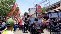 Warga tampak antusias menonton rombongan mobil Jokowi yang melintas. Bahkan, mobil Jokowi tampak dikerumuni warga yang ingin melihatnya lebih dekat dan mendapatkan kaus yang dibagikan Jokowi.