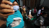 Untuk mendapatkan sayuran gratis, warga harus menukarkan kupon yang telah dibagikan panitia.