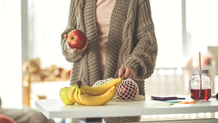 Ilustrasi wanita makan buah apel dan pisang Ilustrasi wanita makan buah apel dan pisang