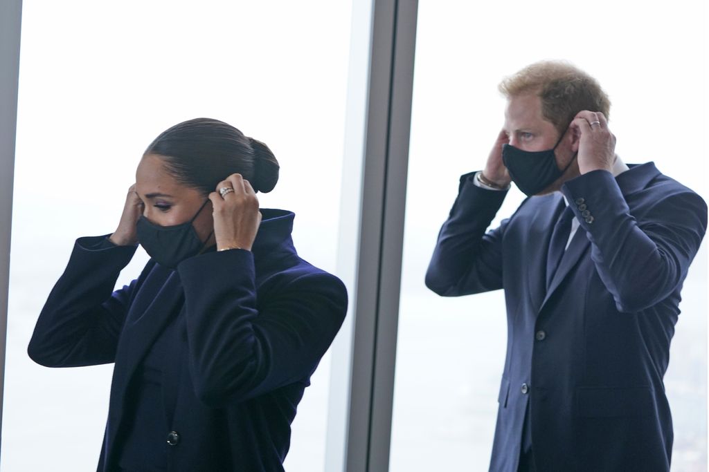 Meghan Markle and Prince Harry pause while getting a tour of the National September 11 Memorial & Museum in New York, Thursday, Sept. 23, 2021. The Duke and Duchess of Sussex got a hawk's-eye view of New York City with a visit to the rebuilt World Trade Center's signature tower. (AP Photo/Seth Wenig)