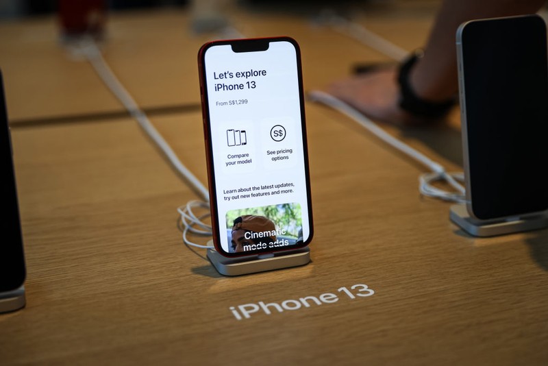 People wait in line to purchase newly released products at the Apple Store in Orchard Road on September 24, 2021 in Singapore. Apple announced September 14 the release of four variants of its latest iPhone 13, alongside other upgrades to its product lineup. (Photo by Feline Lim/Getty Images)