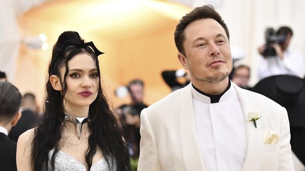 FILE - Grimes, left, and Elon Musk attend The Metropolitan Museum of Art's Costume Institute benefit gala in New York on May 7, 2018. The Tesla and SpaceX founder tells the New York Post that he and the Canadian singer are 