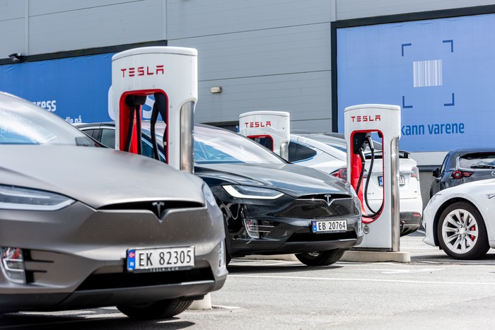 Lyngdal, Norway - August 02 2021: Tesla Superchargers at use at Handelsparken.