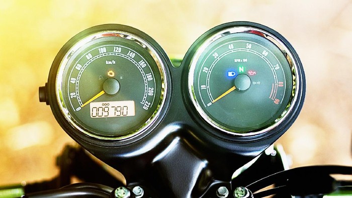 Detail of Retro-style motorbike, showing rev counter and speedometer.