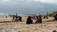 Ramainya kunjungan wisatawan di Pantai Kuta juga dimanfaatkan oleh para pedagang untuk mengais rezeki. Sejumlah pedagang makanan ringan dan minuman juga nampak berkeliling menawarkan dagangannya. (Sui Suadnyana/detikTravel)