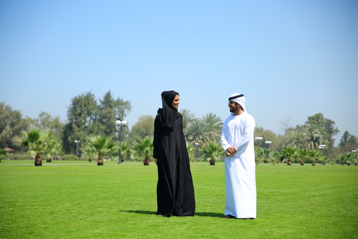 Arab Emirati family outdoors in park.