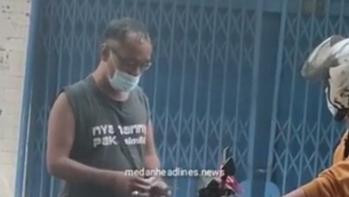 Video memperlihatkan seorang pria diduga melakukan pungutan liar (pungli) di Medan viral di media sosial (medsos). Polisi turun tangan menyelidiki info tersebut. (Screenshot Instagram @medanheadline.news)