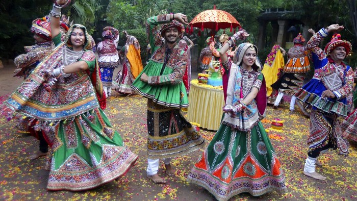 Indian women in traditional attire pose for photographs before practicing Garba, a traditional dance of Gujarat state, ahead of Hindu festival of Navratri in Ahmadabad, India, Friday, Oct. 1, 2021. The Hindu festival of Navratri or nine nights will begin from Oct. 7. (AP Photo/Ajit Solanki)