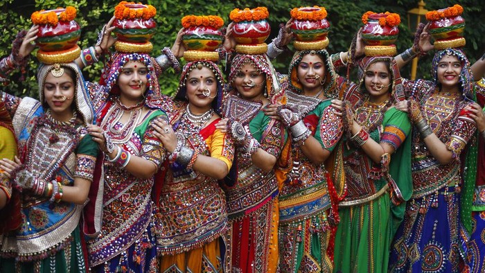 Indian women in traditional attire pose for photographs before practicing Garba, a traditional dance of Gujarat state, ahead of Hindu festival of Navratri in Ahmadabad, India, Friday, Oct. 1, 2021. The Hindu festival of Navratri or nine nights will begin from Oct. 7. (AP Photo/Ajit Solanki)