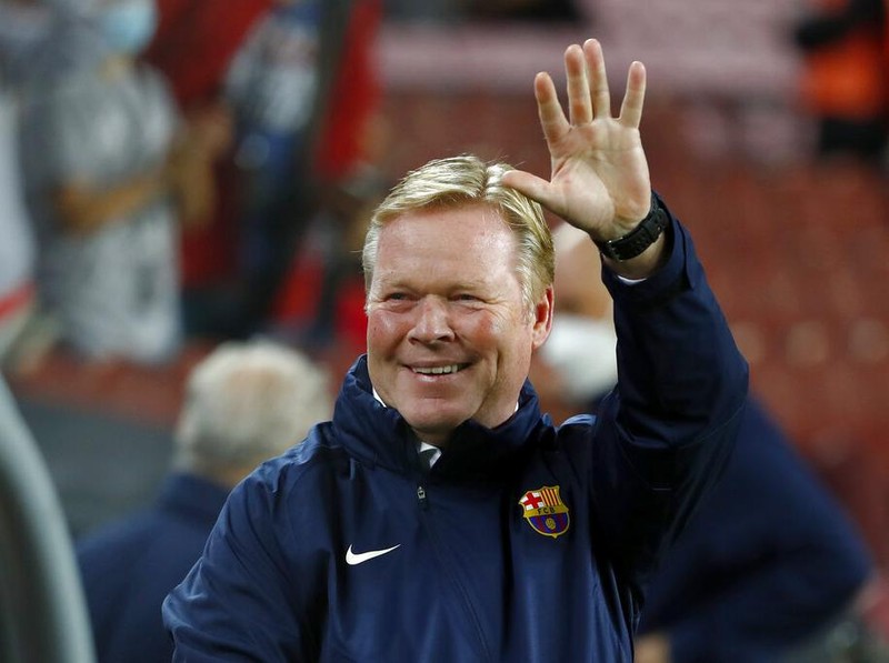 Barcelona's head coach Ronald Koeman waves during the Spanish La Liga soccer match between Barcelona and Granada, at the Camp Nou stadium in Barcelona, Spain, Monday, Sept. 20, 2021. (AP Photo/Joan Monfort)