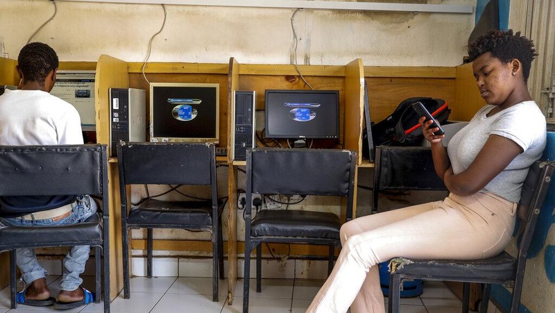 Two young boys use a computer at an internet cafe in the low-income Kibera neighborhood of Nairobi, Kenya Wednesday, Sept. 29, 2021. Instead of serving Africa's internet development, millions of internet addresses reserved for Africa have been waylaid, some fraudulently, including in insider machinations linked to a former top employee of the nonprofit that assigns the continent's addresses. (AP Photo/Brian Inganga)