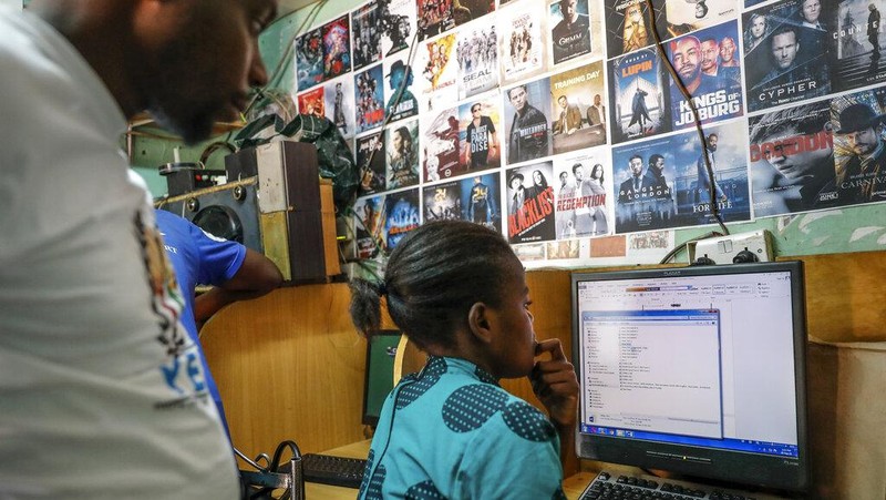 Two young boys use a computer at an internet cafe in the low-income Kibera neighborhood of Nairobi, Kenya Wednesday, Sept. 29, 2021. Instead of serving Africa's internet development, millions of internet addresses reserved for Africa have been waylaid, some fraudulently, including in insider machinations linked to a former top employee of the nonprofit that assigns the continent's addresses. (AP Photo/Brian Inganga)