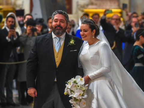 Grand Duke George Mikhailovich Romanov (L) welcomes Victoria Romanovna Bettarini accompanied by her father, Roberto Bettarini, as they arrive for the wedding ceremony at Saint Isaac's Cathedral in Saint Petersburg, on October 1, 2021. - Russia was to hold its first royal wedding, on October 1, 2021, since the 1917 Bolshevik revolution toppled the Romanov monarchy, with royals from across Europe expected at the lavish ceremony. Grand Duke George Mikhailovich Romanov, 40, and his Italian fiance Rebecca Virginia Bettarini, 39, will say their vows at the Saint Isaac's cathedral in the former imperial capital Saint Petersburg in the presence of dozens of royals. (Photo by Olga MALTSEVA / AFP)