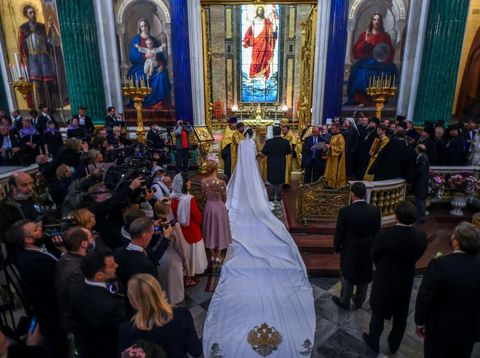 Grand Duke George Mikhailovich Romanov (L) welcomes Victoria Romanovna Bettarini accompanied by her father, Roberto Bettarini, as they arrive for the wedding ceremony at Saint Isaac's Cathedral in Saint Petersburg, on October 1, 2021. - Russia was to hold its first royal wedding, on October 1, 2021, since the 1917 Bolshevik revolution toppled the Romanov monarchy, with royals from across Europe expected at the lavish ceremony. Grand Duke George Mikhailovich Romanov, 40, and his Italian fiance Rebecca Virginia Bettarini, 39, will say their vows at the Saint Isaac's cathedral in the former imperial capital Saint Petersburg in the presence of dozens of royals. (Photo by Olga MALTSEVA / AFP)