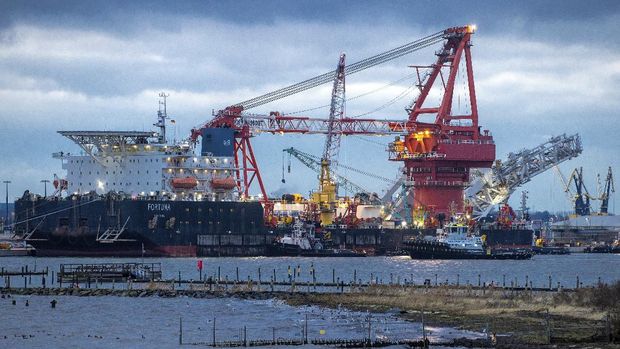 FILE - In this Jan. 14, 2021 file photo, tugboats get into position on the Russian pipe-laying vessel 