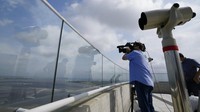 Seorang jurnalis TV merekam sisi perbatasan Korea Utara dari observatorium Aegibong Peace Ecopark di Gimpo, Korea Selatan, Selasa (5/10/2021).  