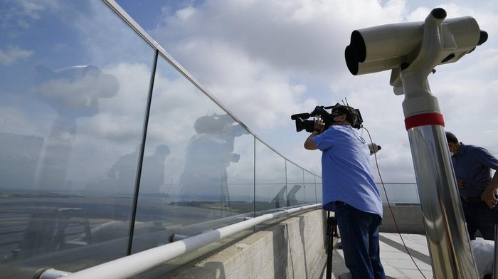 Meneropong Sisi Perbatasan Korea Selatan dan Utara A visitor uses a smartphone to film the North Korea's Kaepoong from the observatory of the Aegibong Peace Ecopark in Gimpo, South Korea, Tuesday, Oct. 5, 2021. (AP Photo/Lee Jin-man)
