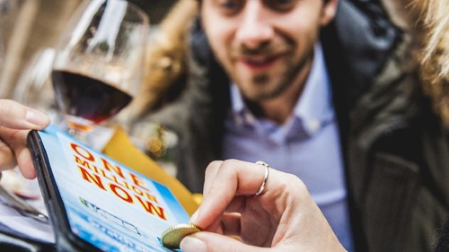 Friends playing together with Lottery scratch game ticket.