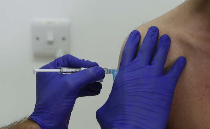 Phase 3 Novavax coronavirus vaccine trial vaccine volunteer Franklyn Howe is given an injection at St Georges University hospital at in London, Wednesday, Oct. 7, 2020. Novavax Inc. said Thursday Jan. 28, 2021 that its COVID-19 vaccine appears 89% effective based on early findings from a British study and that it also seems to work — though not as well — against new mutated strains of the virus circulating in that country and South Africa. (AP Photo/Alastair Grant)