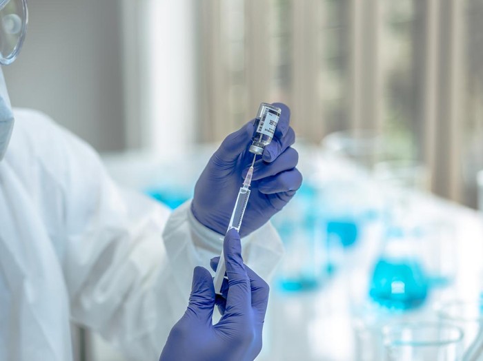 Scientists are done research on vaccine in laboratory with test tubes on Covid19 Coronavirus type for discover vaccine.