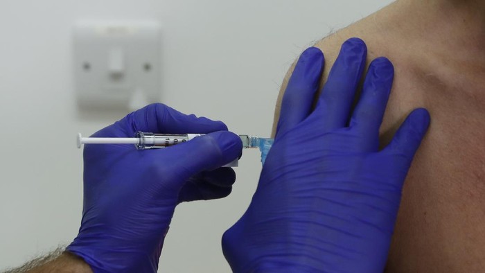 Phase 3 Novavax coronavirus vaccine trial vaccine volunteer Franklyn Howe is given an injection at St Georges University hospital at in London, Wednesday, Oct. 7, 2020. Novavax Inc. said Thursday Jan. 28, 2021 that its COVID-19 vaccine appears 89% effective based on early findings from a British study and that it also seems to work — though not as well — against new mutated strains of the virus circulating in that country and South Africa. (AP Photo/Alastair Grant)