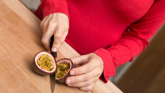 Ilustrasi ibu hamil makan buah markisa