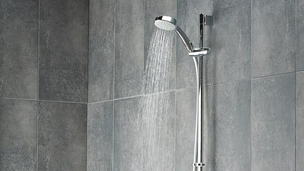 Shower kamar mandi untuk rumah minimalis Shot of running water from shower head in a bathroom
